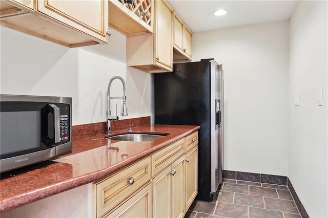 kitchen featuring cream cabinets, stainless steel appliances, and sink