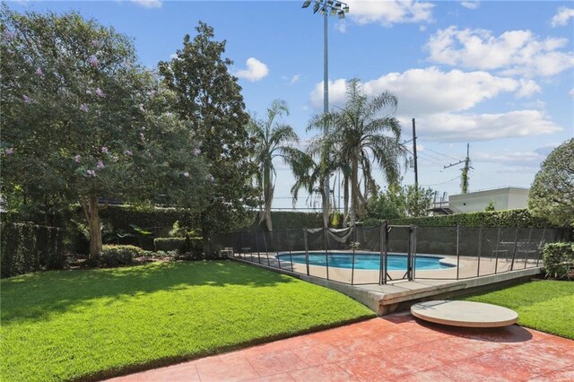 view of pool with a patio and a yard