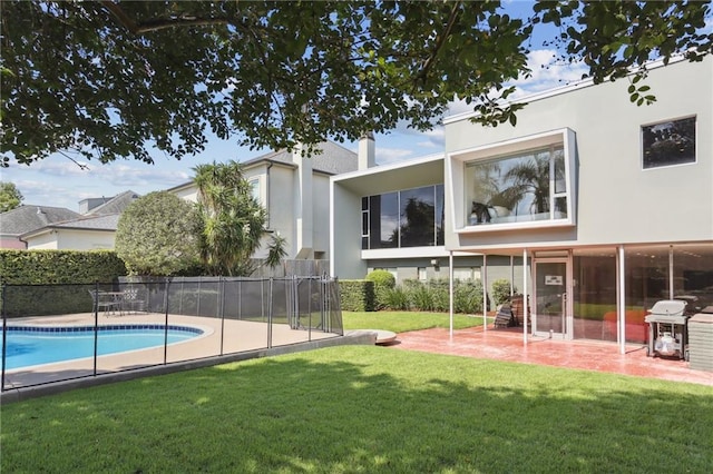 exterior space with a lawn, a fenced in pool, and a patio area