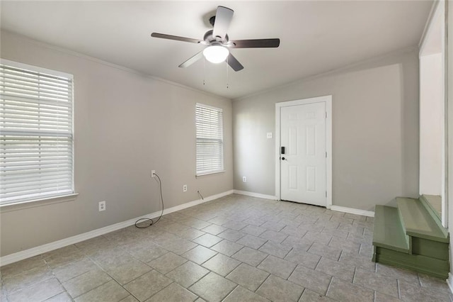 spare room featuring ornamental molding and ceiling fan