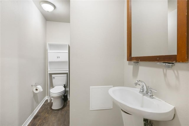 bathroom featuring hardwood / wood-style flooring, sink, and toilet