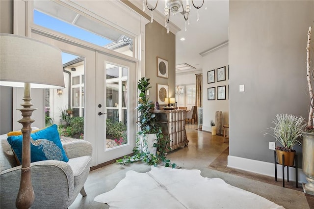 interior space with a high ceiling, a chandelier, concrete flooring, and french doors