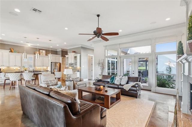 living room featuring ceiling fan and crown molding