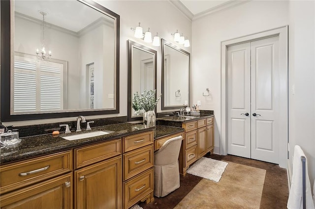 bathroom featuring ornamental molding, vanity, and a notable chandelier