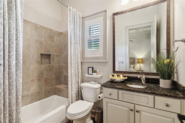 full bathroom featuring shower / bath combination with curtain, vanity, and toilet