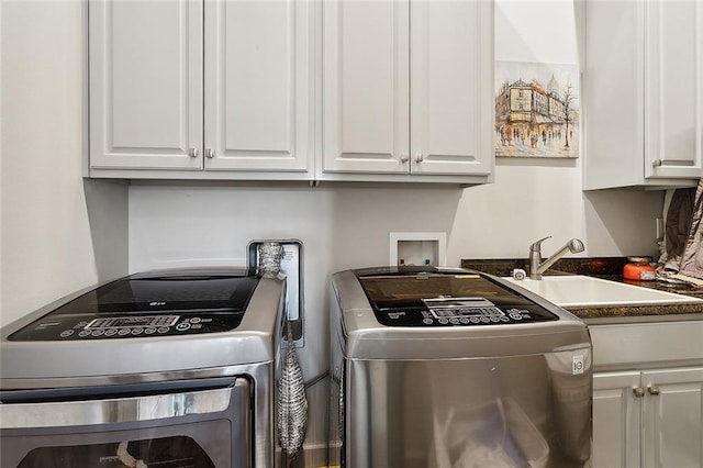 washroom featuring separate washer and dryer, cabinets, and sink