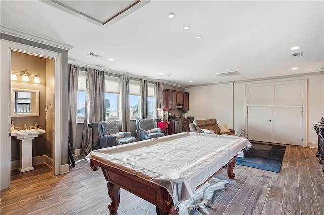 recreation room with pool table, ornamental molding, and hardwood / wood-style floors