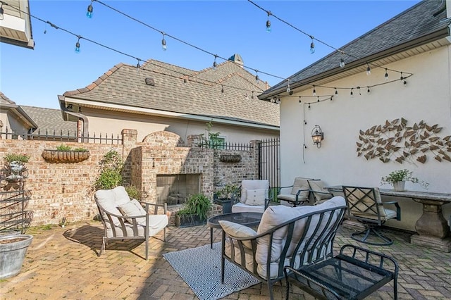 view of patio with an outdoor fireplace