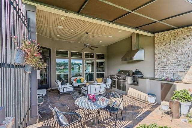 view of patio / terrace with ceiling fan, a grill, and exterior kitchen