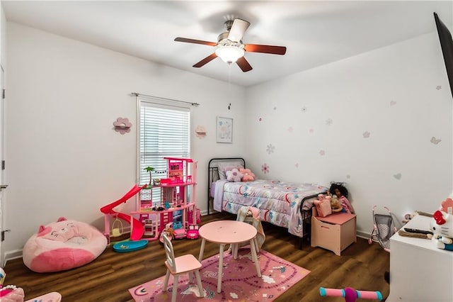 bedroom with dark hardwood / wood-style floors and ceiling fan