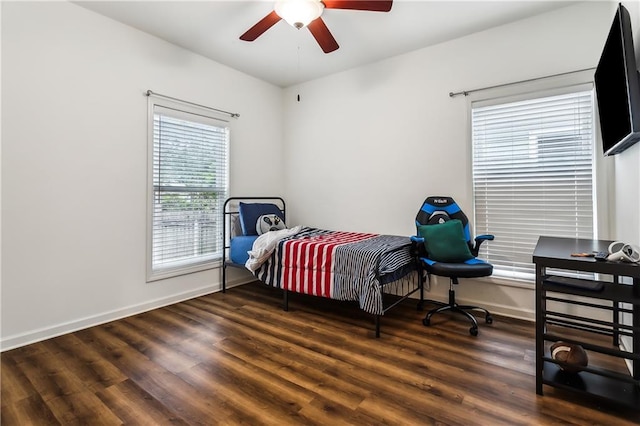 bedroom with ceiling fan and dark hardwood / wood-style flooring