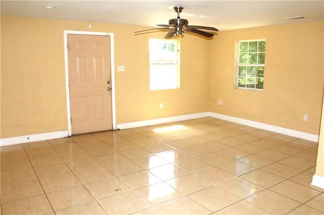 tiled empty room with ceiling fan