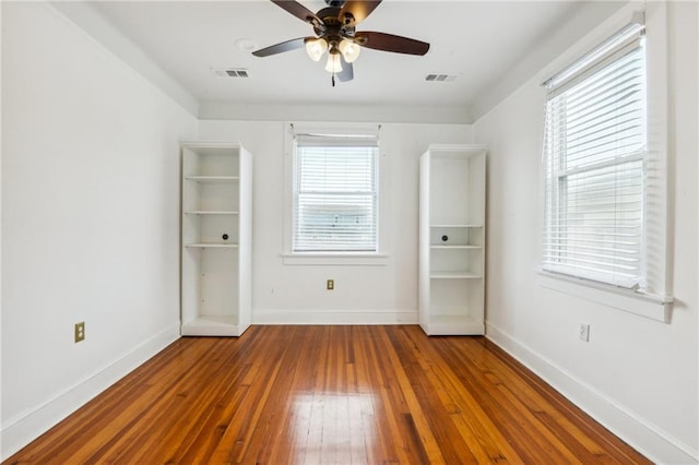 unfurnished bedroom with ceiling fan and hardwood / wood-style flooring