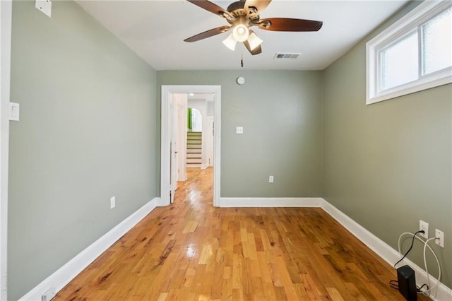 empty room with light hardwood / wood-style flooring and ceiling fan