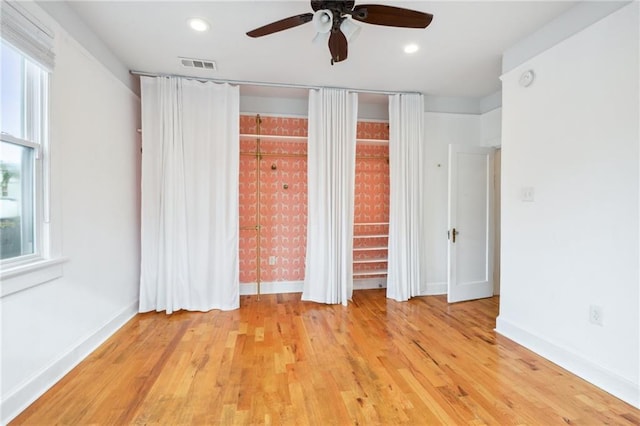 unfurnished bedroom with light hardwood / wood-style floors and ceiling fan