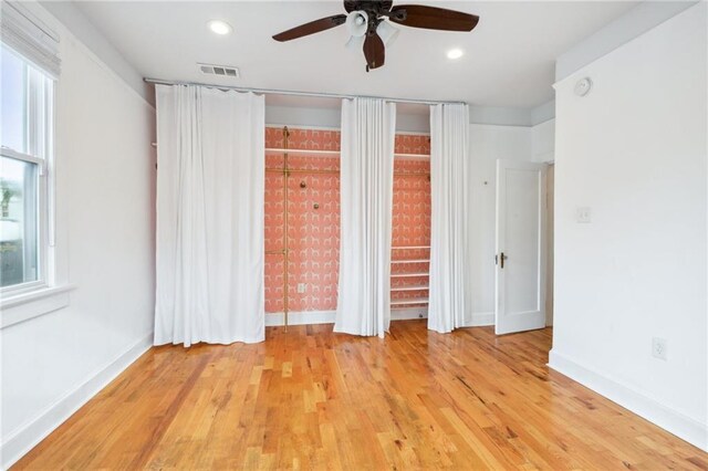 unfurnished bedroom featuring recessed lighting, visible vents, light wood-style flooring, and baseboards