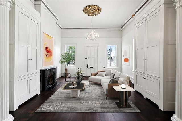 living room with ornamental molding, dark hardwood / wood-style floors, and a chandelier