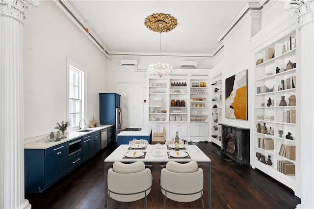 dining area with dark hardwood / wood-style floors, sink, crown molding, and a chandelier