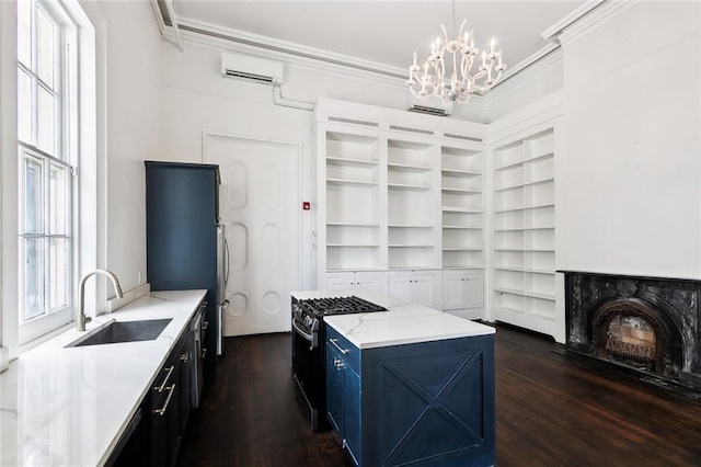 kitchen featuring hanging light fixtures, sink, black range with gas cooktop, and dark wood-type flooring