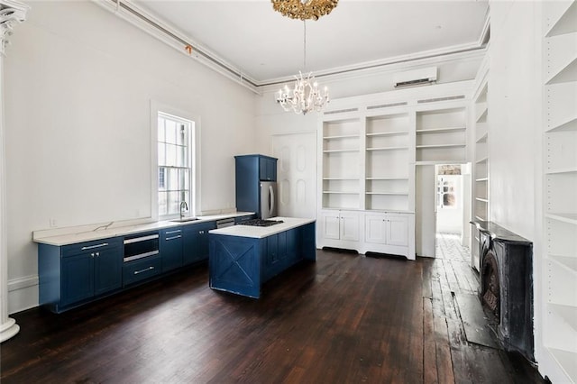 office with dark wood-type flooring, a wall unit AC, ornamental molding, sink, and a chandelier