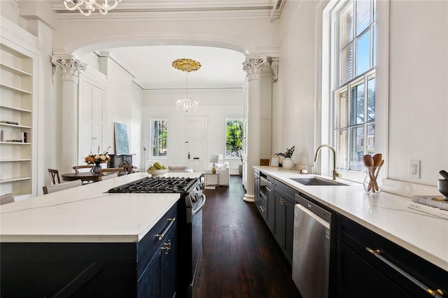 600 Esplanade Ave Unit 1, New Orleans, LA 70116 - kitchen with a sink, an inviting chandelier, dark cabinetry, and appliances with stainless steel finishes