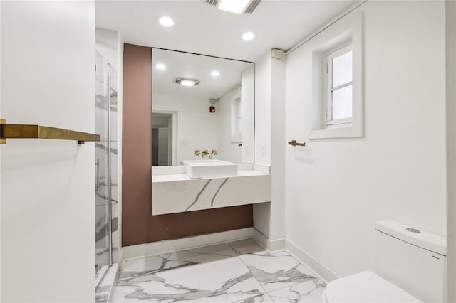 bathroom featuring vanity, toilet, and an enclosed shower