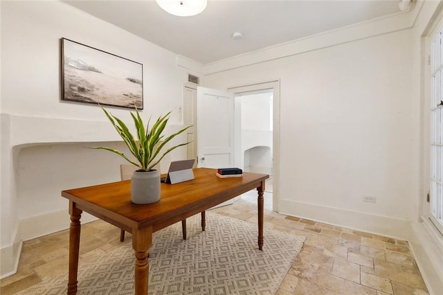 600 Esplanade Ave Unit 1, New Orleans, LA 70116 - office area with stone tile flooring, crown molding, visible vents, baseboards, and arched walkways