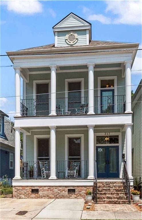 view of front of property with a balcony and covered porch