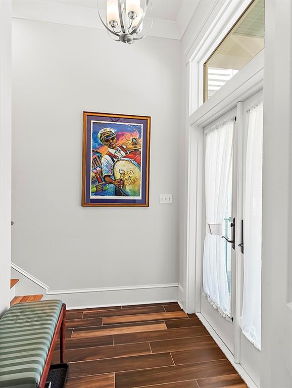 entryway featuring an inviting chandelier and dark hardwood / wood-style flooring