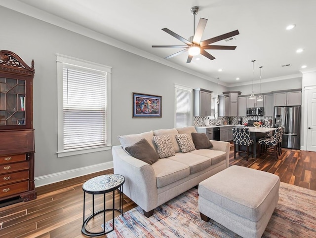 living room with a healthy amount of sunlight, dark wood-type flooring, and ceiling fan