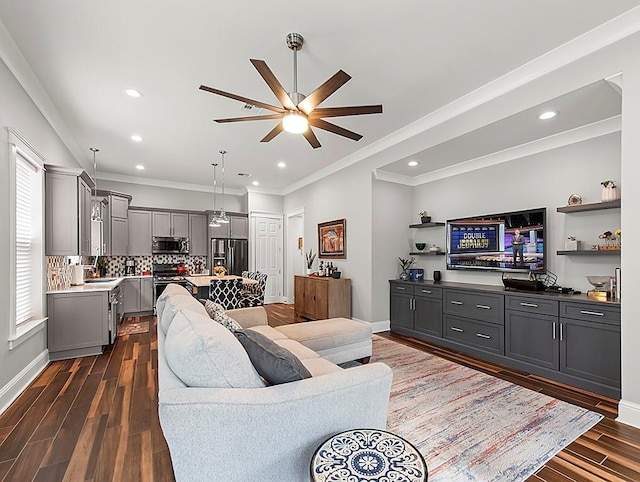 living room featuring ornamental molding, dark hardwood / wood-style floors, ceiling fan, and sink