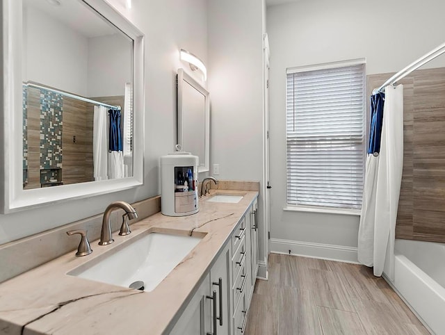 bathroom featuring a healthy amount of sunlight, vanity, shower / tub combo, and hardwood / wood-style flooring