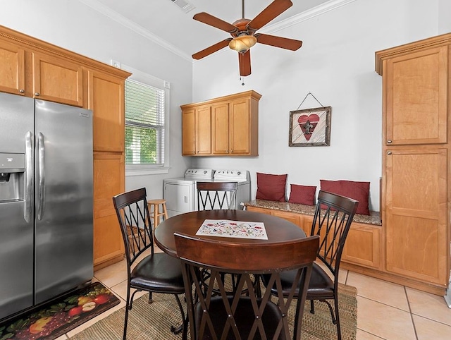 dining room featuring light tile patterned floors, separate washer and dryer, ornamental molding, and ceiling fan