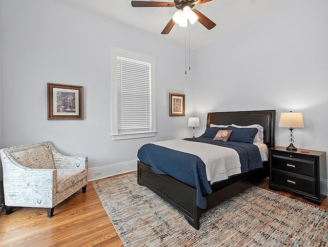 bedroom with wood-type flooring and ceiling fan