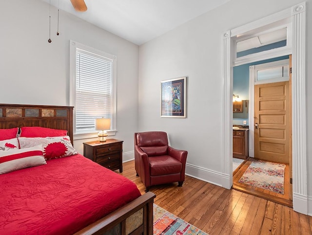 bedroom with light hardwood / wood-style floors, ceiling fan, and ensuite bathroom