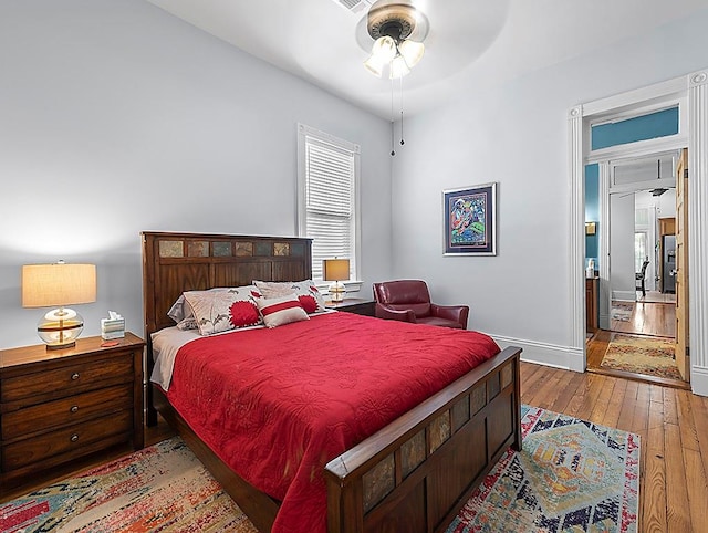 bedroom with wood-type flooring and ceiling fan