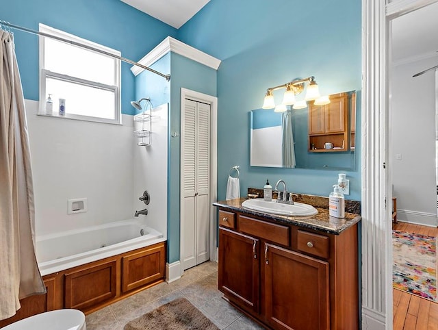 full bathroom featuring shower / tub combo, vanity, hardwood / wood-style floors, and toilet