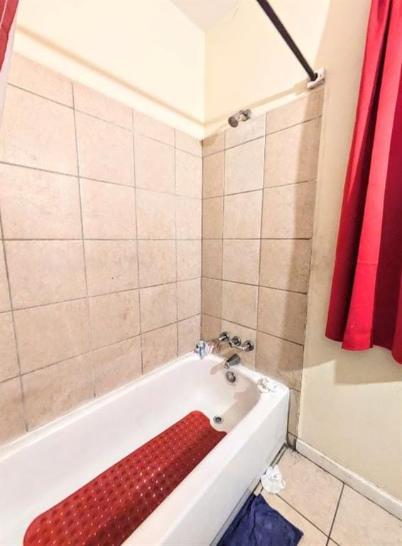 bathroom with tile patterned flooring and tiled shower / bath