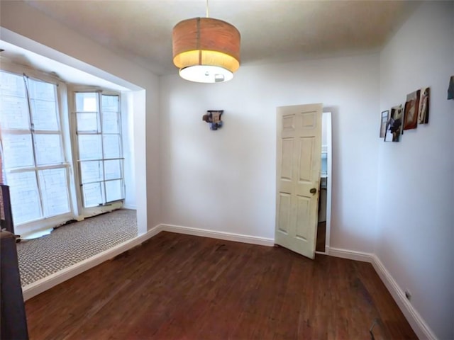 empty room with dark wood-type flooring