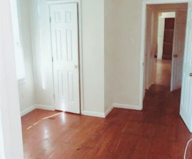 hallway with dark wood-type flooring