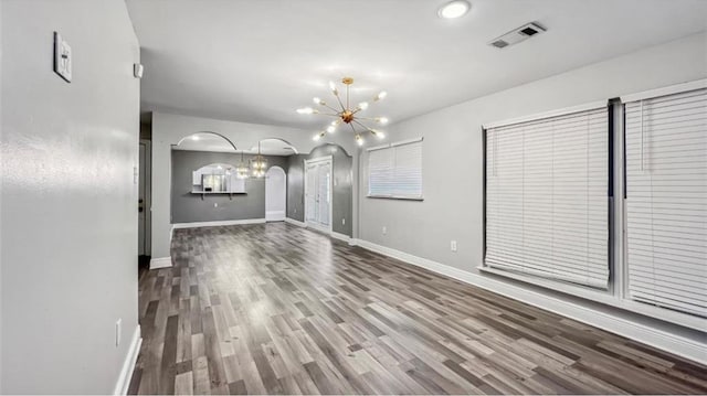 kitchen with light tile patterned flooring, white cabinets, stainless steel appliances, an inviting chandelier, and sink