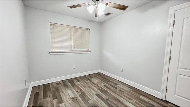 unfurnished room with ceiling fan and dark wood-type flooring