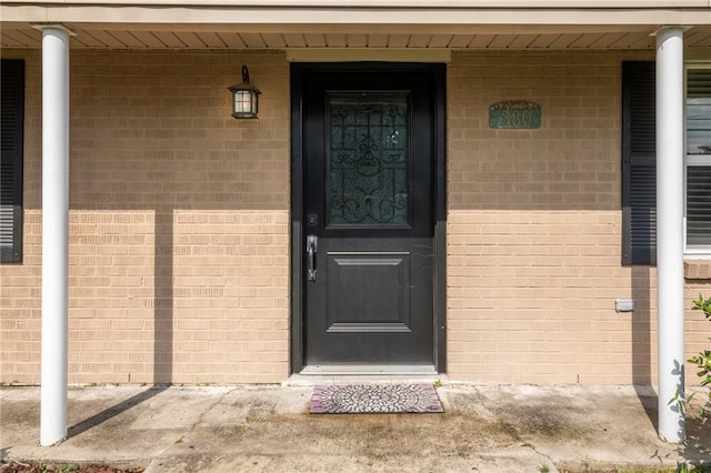 view of exterior entry featuring a porch