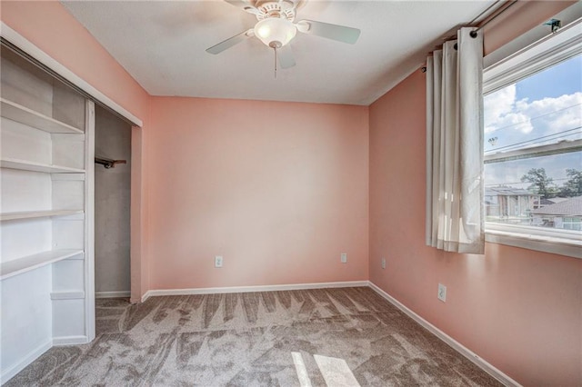 unfurnished bedroom featuring light carpet, a closet, and ceiling fan