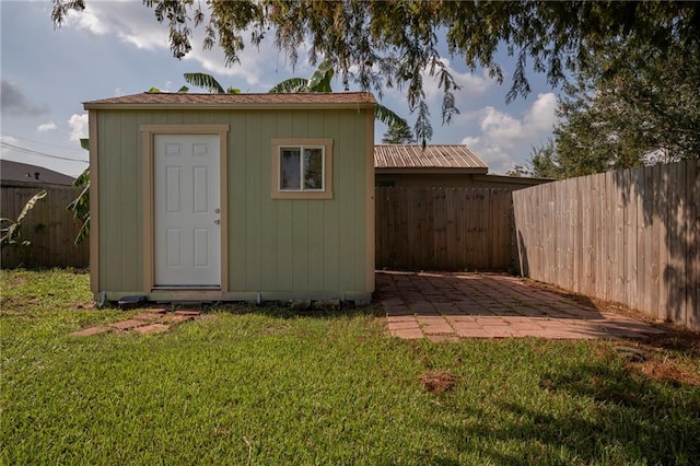 view of outdoor structure featuring a lawn