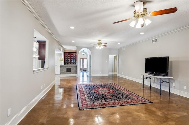 unfurnished living room with ceiling fan, crown molding, and a textured ceiling