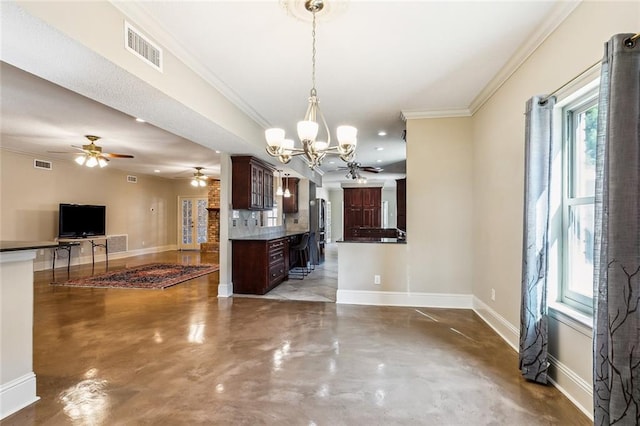 unfurnished dining area featuring concrete floors, ornamental molding, and a notable chandelier