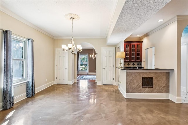 kitchen featuring a chandelier, plenty of natural light, pendant lighting, and a textured ceiling