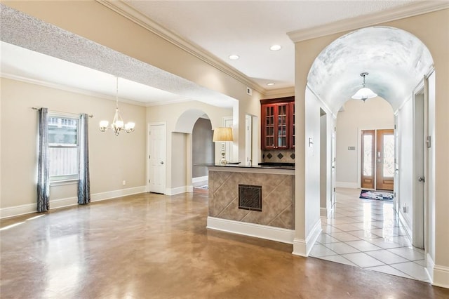 kitchen featuring a chandelier, hanging light fixtures, ornamental molding, and light tile patterned flooring