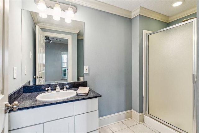 bathroom with vanity, crown molding, ceiling fan, and a shower with shower door